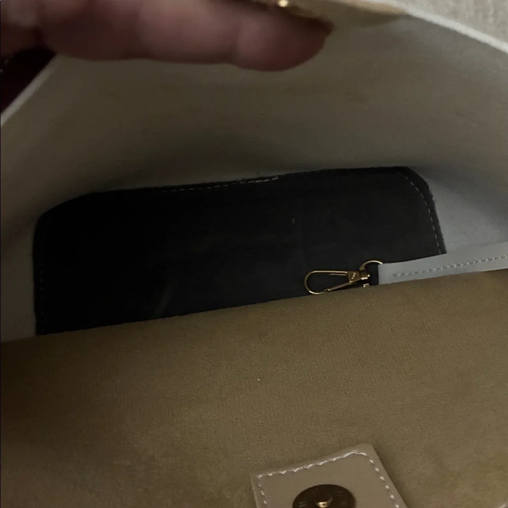 Tan purse‎ with sleek design and smooth finish.